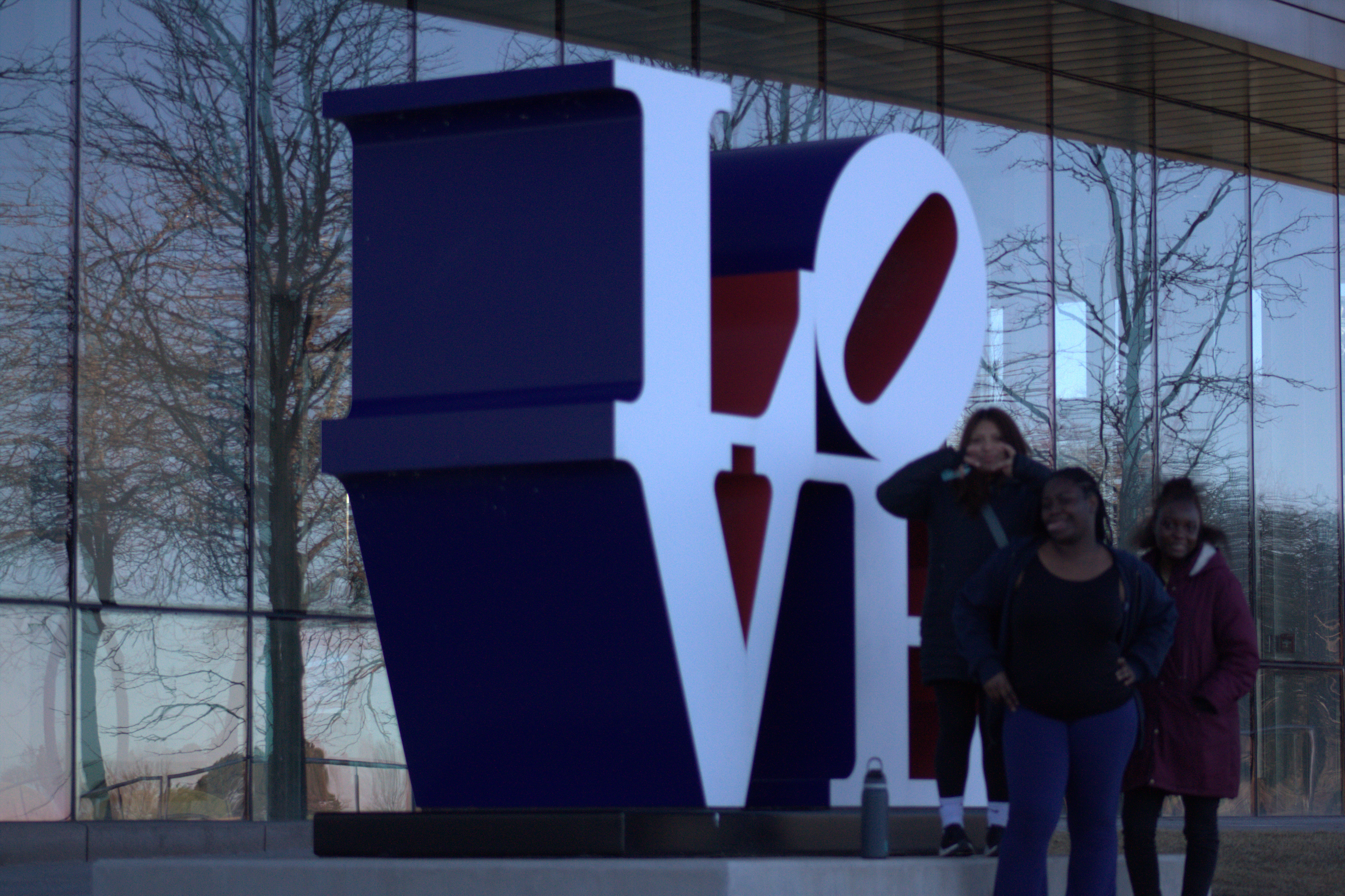 man standin infront of water hands out on the beach