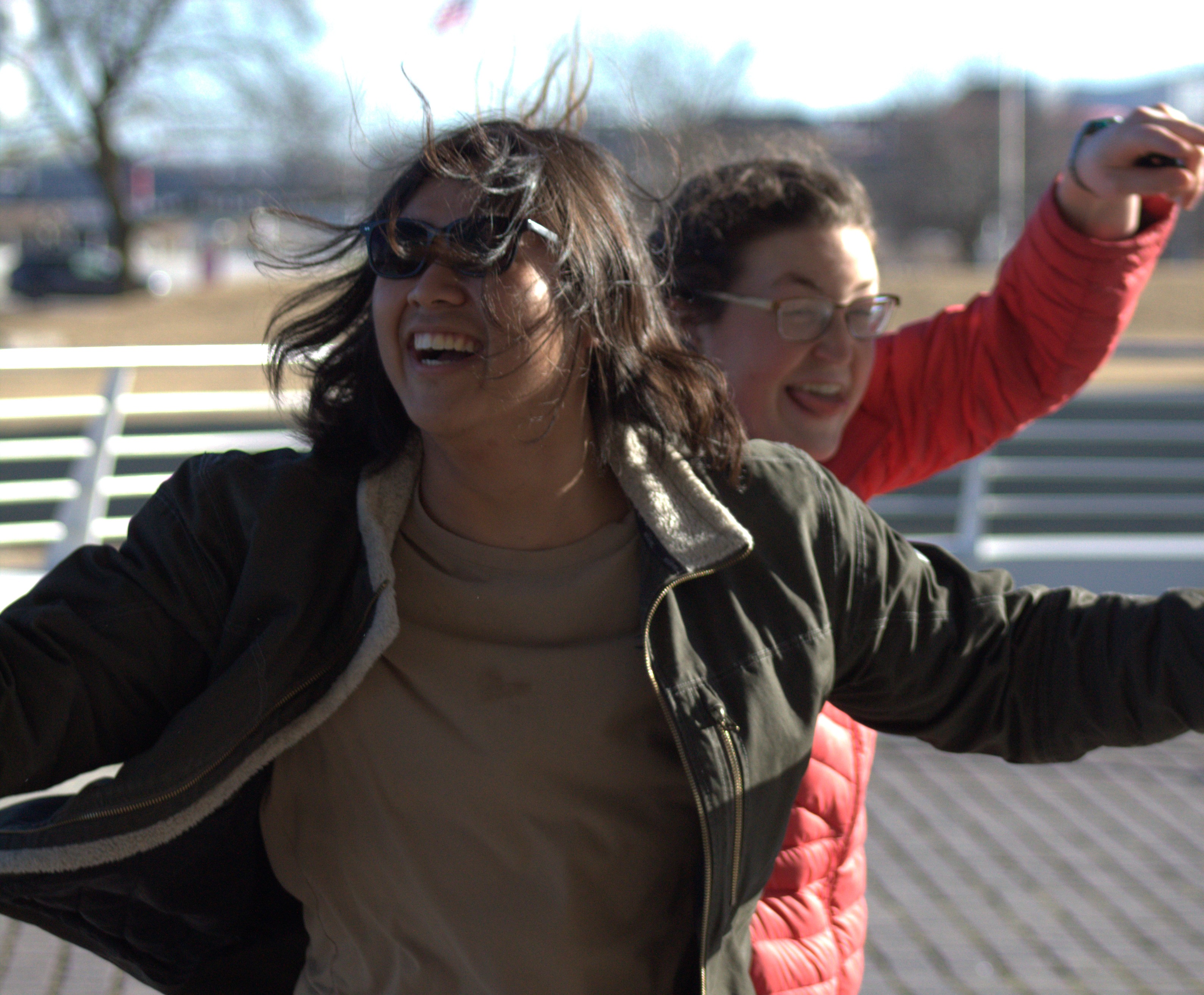 A young woman and man having a blast jumping in the air