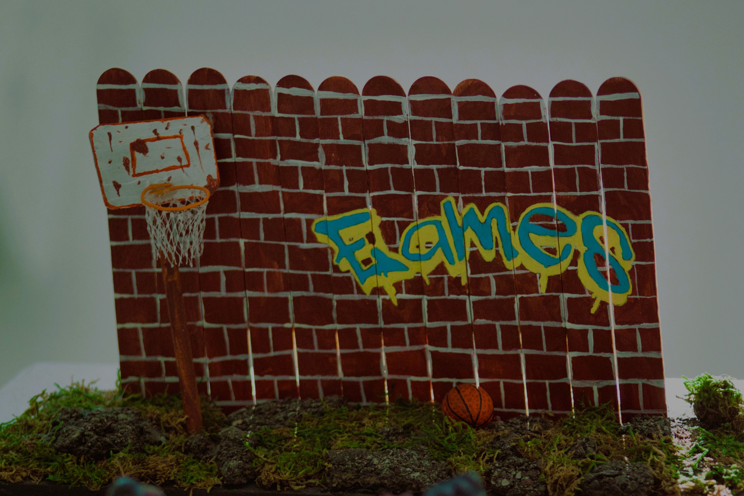 Basketball hoop with flames spraypainted on the wall