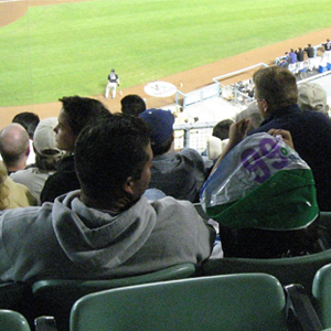 Son watching baseball with his dad